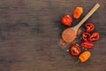 Different ripe chili peppers and spoon with spice on wooden table, flat lay. Space for text Royalty Free Stock Photo