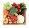 Different ripe vegetables in wicker box isolated on white, top view Royalty Free Stock Photo