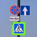 Different road signs on a pole