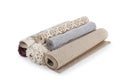 Different rolled carpets on white background Royalty Free Stock Photo