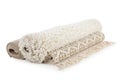 Different rolled carpets on white background.