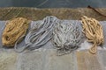 Different ropes to tie boats, old rusty chains used in fishing i Royalty Free Stock Photo