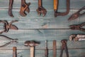 Different rusty construction instruments on the green wooden background Royalty Free Stock Photo
