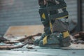 Different safety equipment for arborist or arborists such as boots, shoes, knee and shin guards on safety trousers. Detail of