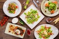 Different salads on wooden table, top view. Royalty Free Stock Photo