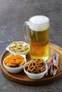 Different salted snacks and a glass of fresh beer Royalty Free Stock Photo