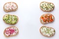 Different sandwiches with grain bread, vegetables and microgreens on a white background Royalty Free Stock Photo
