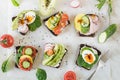 Different sandwiches with vegetables, eggs, avocado, tomato, rye bread on light marble table. Top view. Appetizer for party. Flat Royalty Free Stock Photo