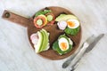 Different sandwiches with vegetables, eggs, avocado, tomato, rye bread on light marble table. Top view. Appetizer for party. Flat Royalty Free Stock Photo