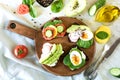Different sandwiches with vegetables, eggs, avocado, tomato, rye bread on light marble table. Top view. Appetizer for party. Flat Royalty Free Stock Photo