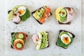 Different sandwiches with vegetables, eggs, avocado, tomato, rye bread on light marble table. Top vew. Appetizer for party. Flat l Royalty Free Stock Photo