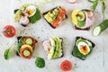 Different sandwiches with vegetables, eggs, avocado, tomato, rye bread on light marble table. Top vew. Appetizer for party. Flat l Royalty Free Stock Photo