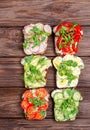 Different sandwiches with vegetables and microgreens on toast bread on a wooden background Royalty Free Stock Photo