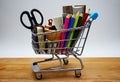 Different school supplies in a supermarket trolley. Back to school concept Royalty Free Stock Photo