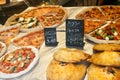 Different see pizzas on display in an italian store or bar