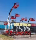 Different self propelled articulated boom lifts and one scissor lift Royalty Free Stock Photo