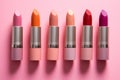 Different shaded lipsticks on pink background