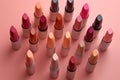 Different shaded lipsticks on pink background