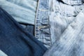 Different shades of blue denim fabric. Detail of several layers of jeans