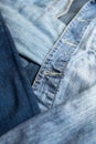 Different shades of blue denim fabric. Detail of several layers of jeans