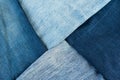 Different shades of blue denim fabric. Detail of several layers of jeans