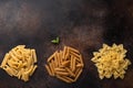 Different shapes of pasta on dark background. top view. copy space. Royalty Free Stock Photo