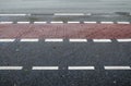 Different signs and marking painted on the ashpalt of streets and roads