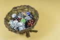 Different size and color dice placed inside a wooden nest