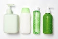 Different size and shapes containers for cleanser toner tonic conditioner, soap and shampoo on white background with water drops.