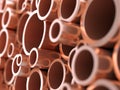 Different sized copper pipes heap 3D background