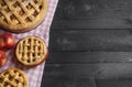 Different sizes apple pies on a rustic table. Above view with copy space Royalty Free Stock Photo