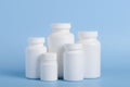Different sizes of blank white plastic bottles of medicine pills or supplements Royalty Free Stock Photo
