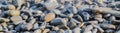 Wet stones on the sea shore suitable for header or footer