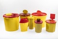 Different sizes of Medical waste bins 1.3, 2, 3, 5 liter. Yellow biohazard medical contaminated and sharp clinical waste