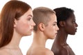 Different skin tones. Side view of three beautiful multicultural young women.Two caucasian and african half naked women Royalty Free Stock Photo