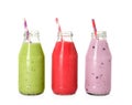Different smoothies in glass bottles on white background Royalty Free Stock Photo