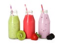 Different smoothies in glass bottles on white background Royalty Free Stock Photo