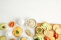 Different snacks with salted crackers on white wooden table, flat lay. Space for text Royalty Free Stock Photo