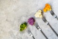 Different sort of cauliflower cabbage on grey concrete background with forks. Top view with copy space Royalty Free Stock Photo