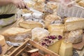 Different sorts of cheese wheels at a market Royalty Free Stock Photo