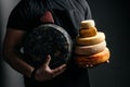 Different sorts of hard cheese wheels in the hands of a cheesemaker, dairy products Royalty Free Stock Photo
