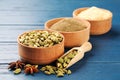 Different spices on blue wooden table, focus on cardamom Royalty Free Stock Photo