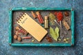 Different spices, dry kitchen herbs and seeds for tasty meals and mock-up of craft paper notebook Royalty Free Stock Photo