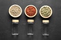 Different spices and glass jars on black table, flat lay Royalty Free Stock Photo