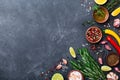 Different Spices And Herbs On Black Stone Table Top View. Ingredients For Cooking. Food Background.