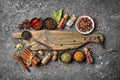 Different spices, kitchen herbs and seeds for tasty meals with wooden board Royalty Free Stock Photo