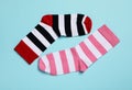 Different stiped socks on light blue background, flat lay Royalty Free Stock Photo