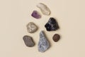 Different stones, precious and rocks on a beige background. Gemological concept. Study of minerals and bowels of the earth.