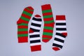Different striped socks on grey background, flat lay