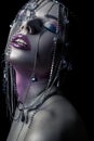 Different style of beauty. young beautiful fashion model with silver, purple, blue makeup and shiny silver jewelry chain on her fa